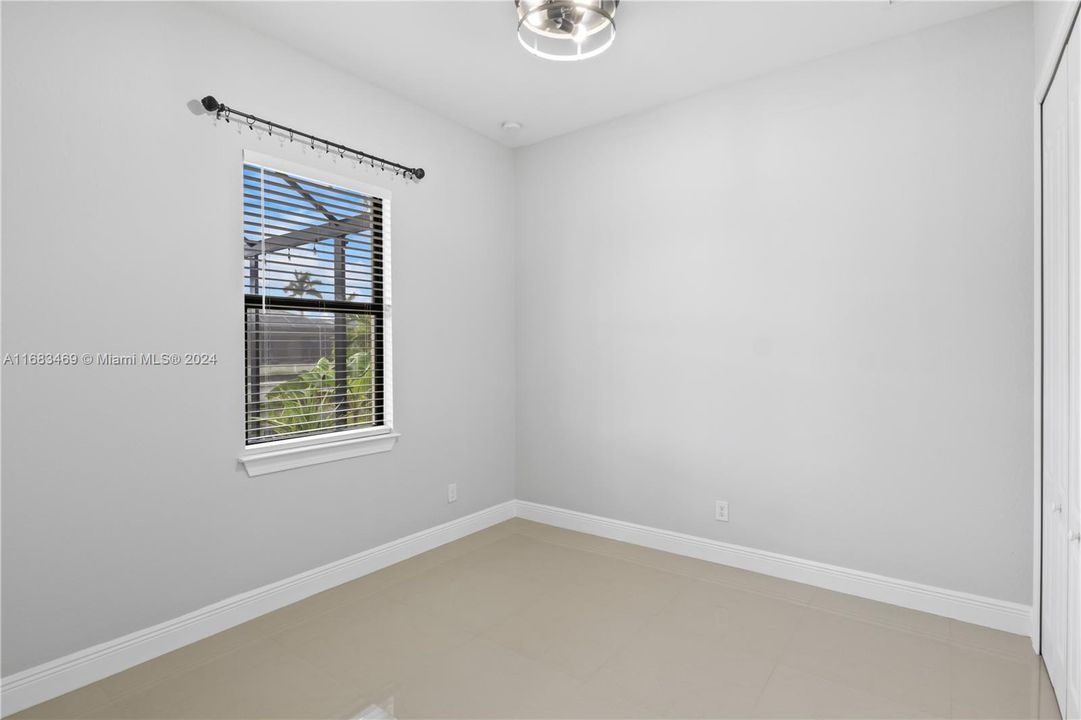 Guest bedroom #1 with tiled floors and upgraded ceiling fan!