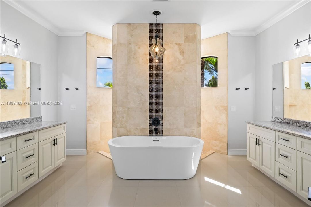 Bathroom with a bathing tub, tile walls, tile patterned floors, and vanity