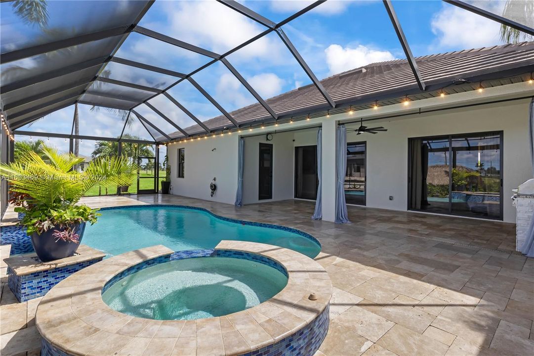 Kick back and relax year round in this pool and spa combo with water fountains and an extensive outdoor living area!