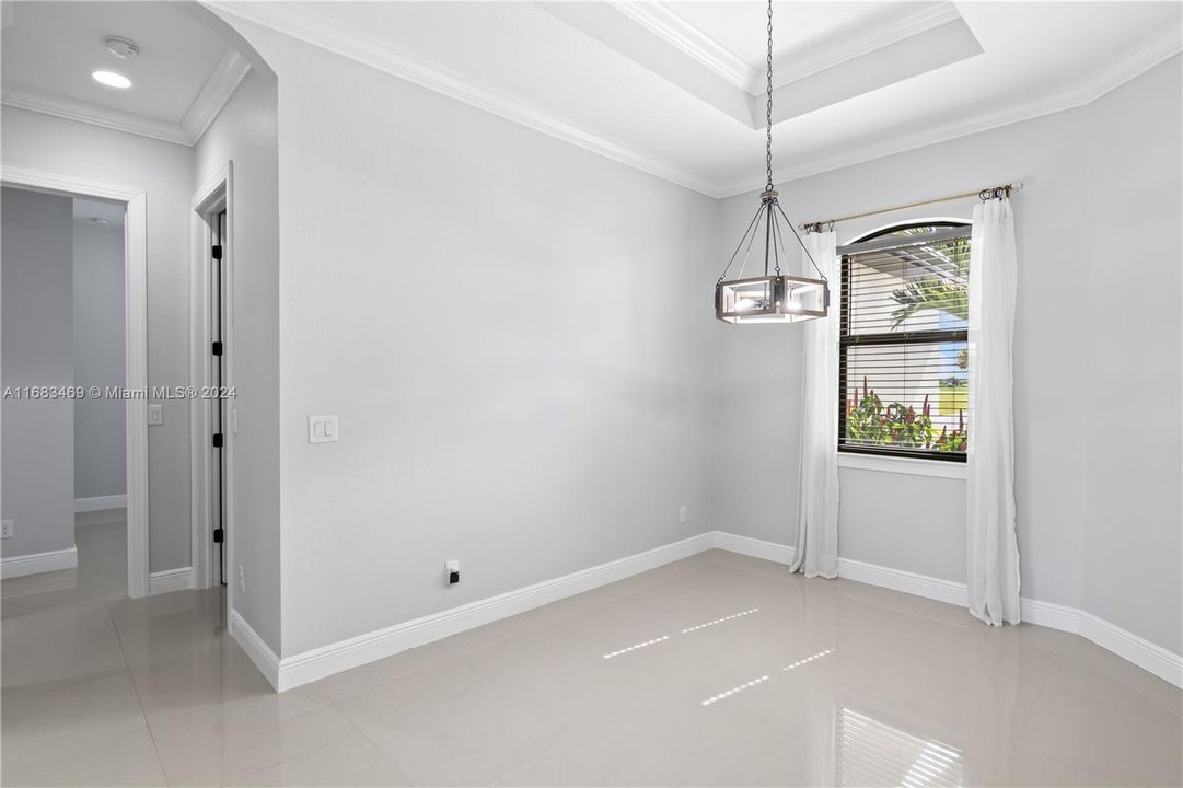 Dining area with tray ceilings, crown molding and upgraded lighting!