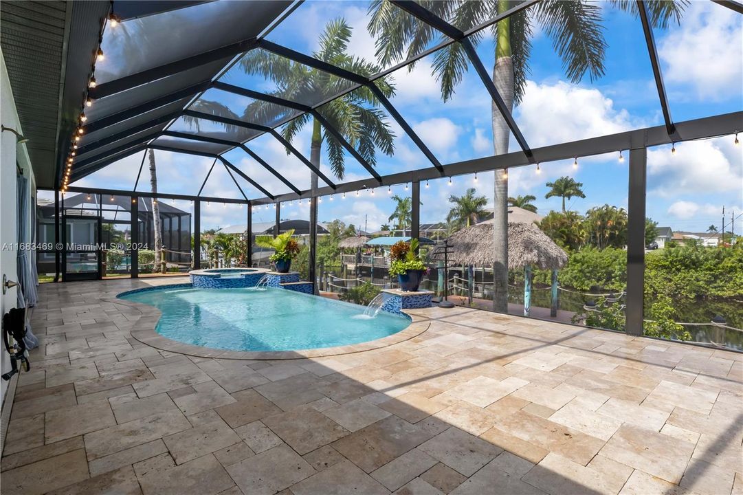 Not only is there a large covered patio for shade, but the patio runs the length of the home and features a large lounging area, outdoor shower and a pool bath!