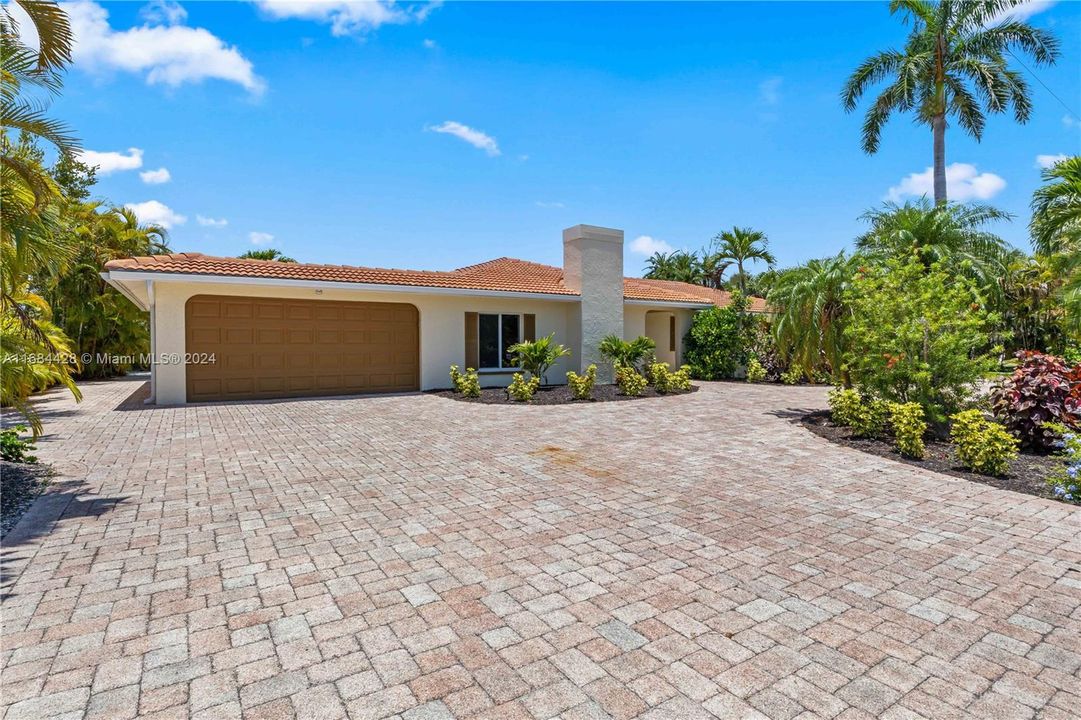 Need lots of parking? This wrap around circular drive will easily hold ten cars! Paved driveway beautiful gardens welcome you to this extraordinary home in Gumbo Limbo!