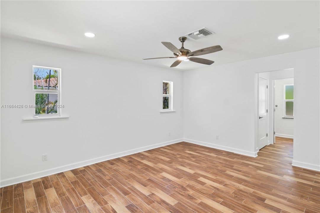 Master bedroom with ceramic tile floors, hurricane impact windows and a master bath retreat.