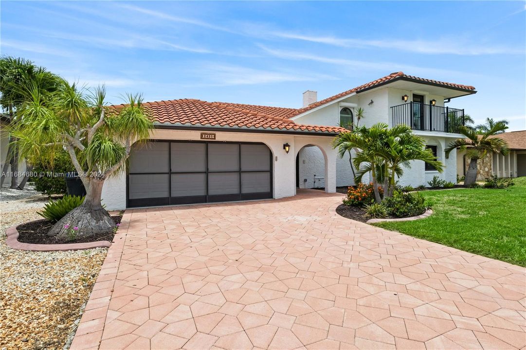 Mediterranean style custom home with large driveway and all kinds of extras you will notice everywhere! Enjoy working in your screened garage - no pesky bugs!!!