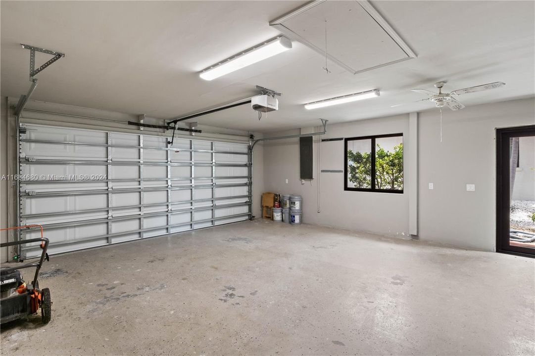 Garage featuring a garage door opener and ceiling fan