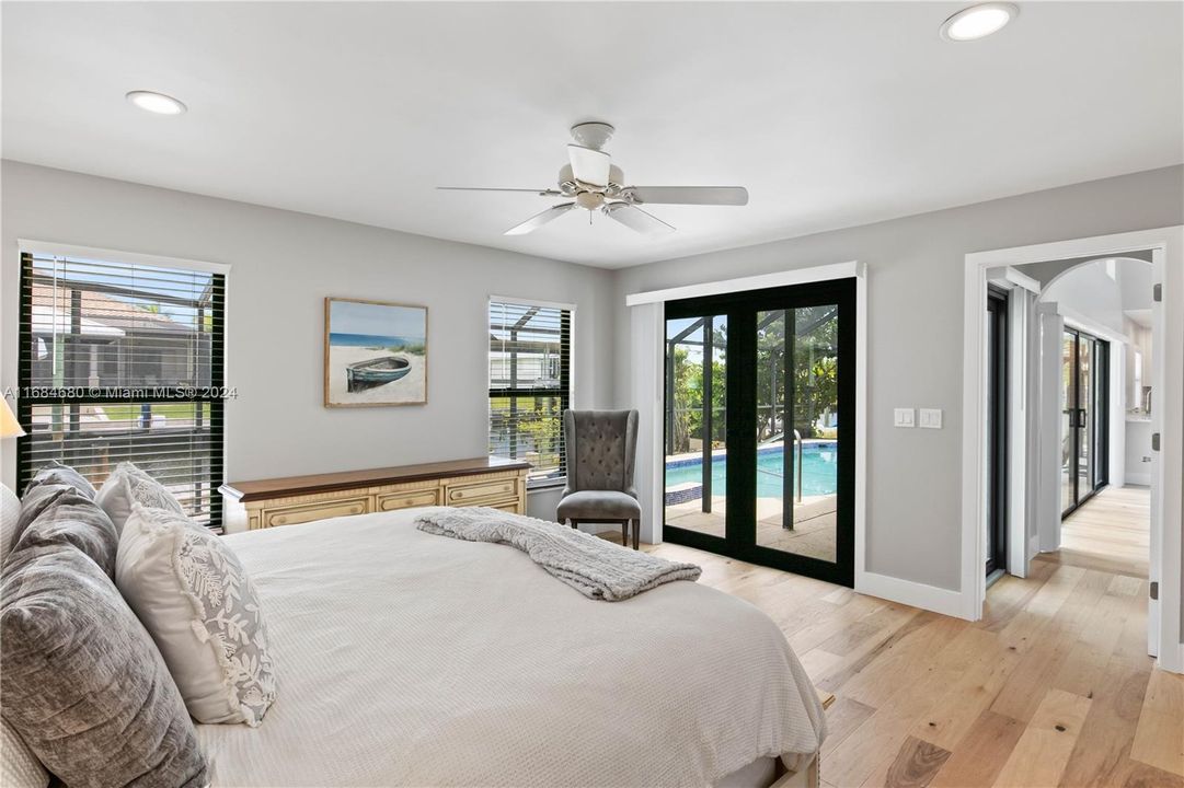 Master bedroom featuring french doors, access to outside, light wood-type flooring, and lots of natural light!