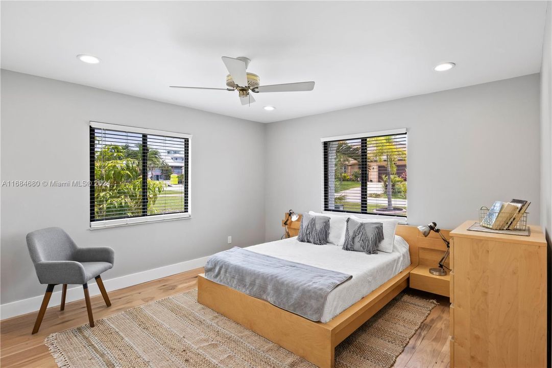 Second Master Bedroom featuring light hardwood / wood-style floors, multiple windows, and split from the other master for privacy!