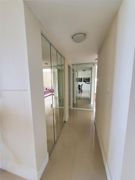 Hall with mirrored linen closet