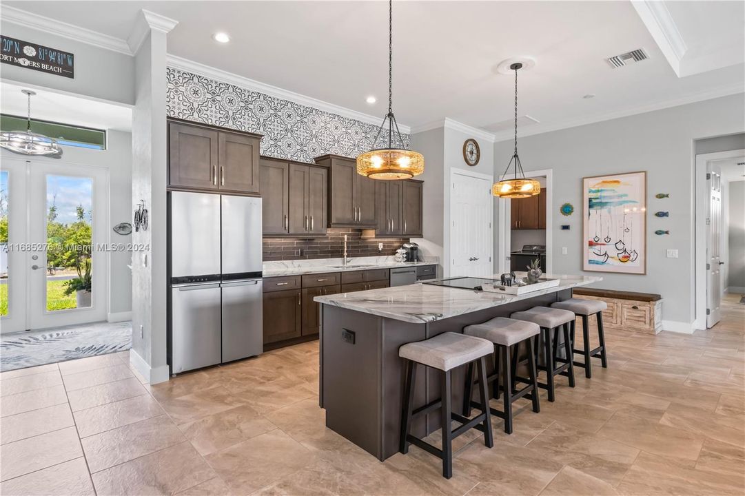 No details missed here - large island, staggered cabinets, GORGEOUS custom tile backsplash and stunning granite!