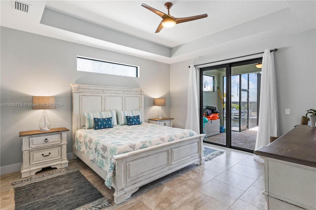 A very spacious and private master retreat that is split from the other bedrooms and offers private access to the outside patio! Detailed tray ceiling, neutral tile floors and a transom window to allow that natural light in!