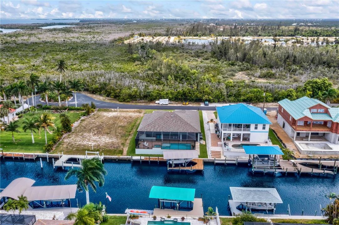 Birds eye view of property - wide canal, established neighborhood, close to many restaurants yet surrounded by nature.