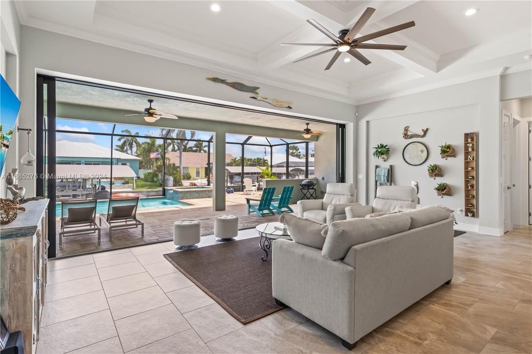 Another view of the living area looking out to the full size patio, pool and spa. Look at all the details throughtout!