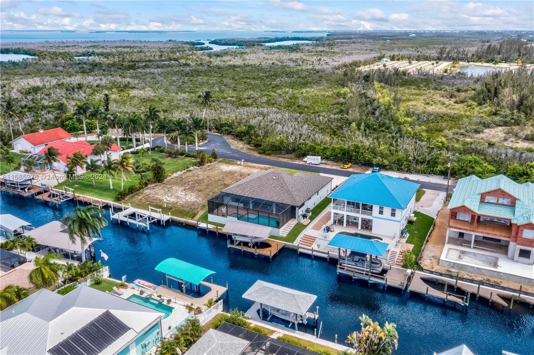 Beautiful aerial view showing the privacy of the culdesac - you truly are close to nature - both on land and water! If you look closely you will see an osprey nest in the culdesac! The parking area across from the home is part of this property also - one of a kind in every way!