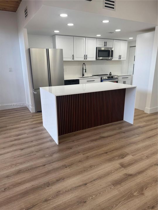 island counter with waterfall quartz & beautiful wood struts design