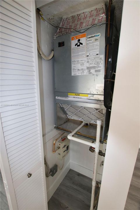 Hall closet with tankless water heater and A/C