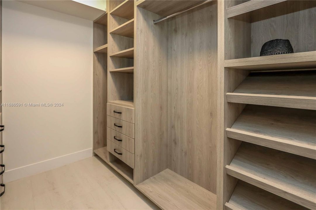 Walk in closet with custom made cabinets