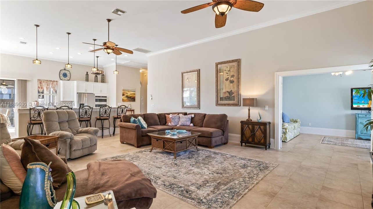 View from the family room into the kitchen - the ceiling heights are 12 foot and higher making the home seem even larger than it is, and while always having a light and bright open concept!