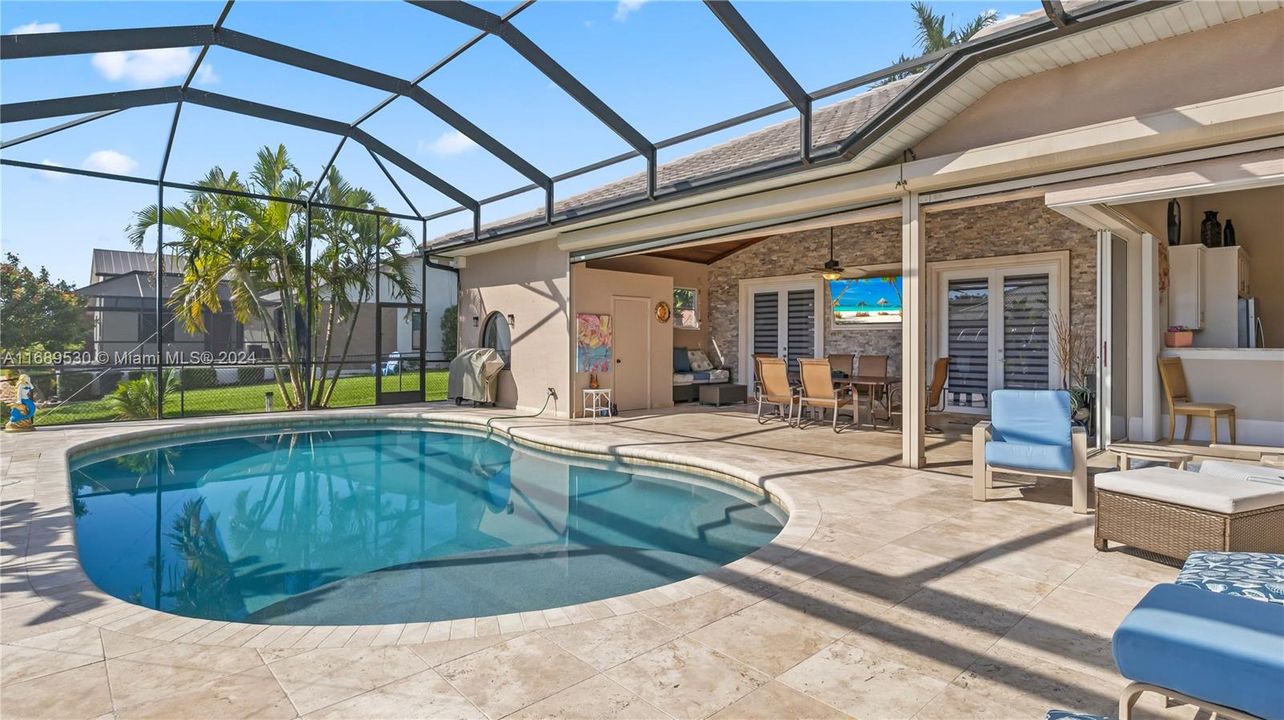 View of the lanai and pool. There is also a storage closet which iis convenient to store pool toys etc.