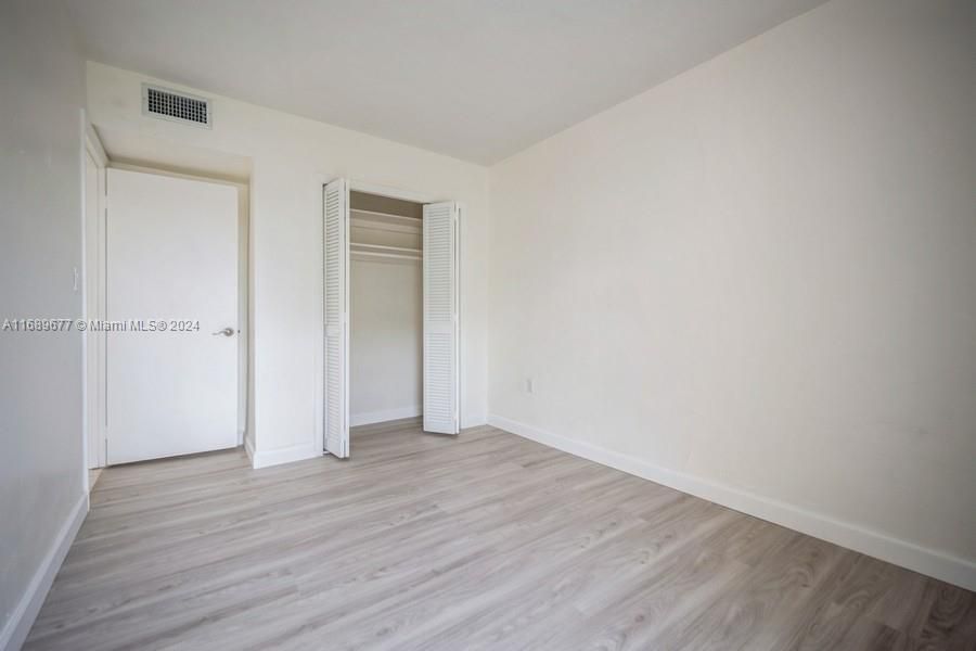 This is the SW bedroom and the 3rd bedroom that has it's new laminated wood floors and good sized closet.