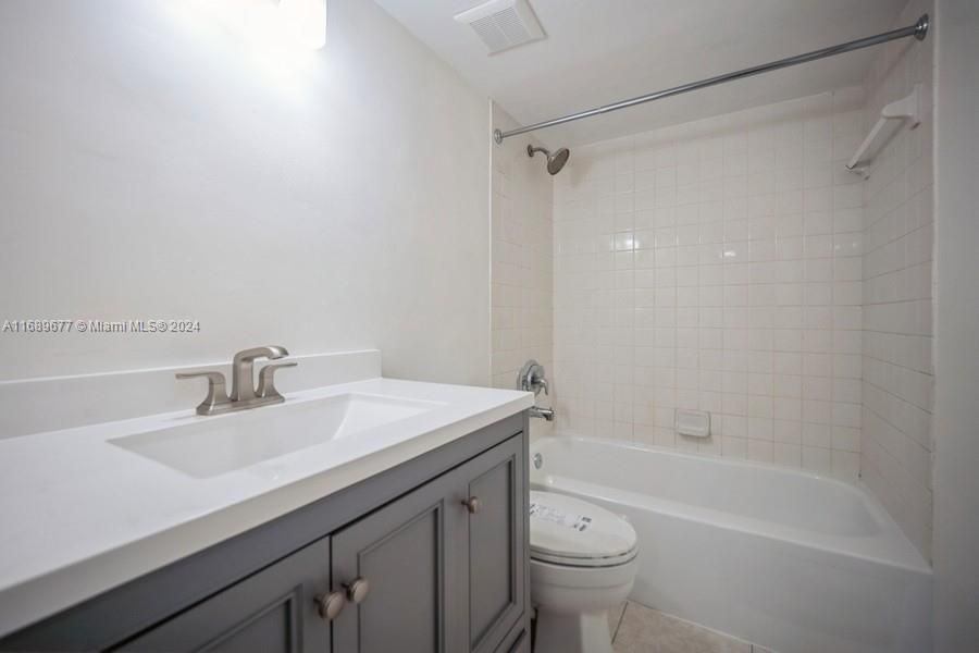 Here is the Hall Bath serving the 2 bedrooms upstairs. Notice the new 32' vanity with it's sink & faucet, a new Kohler toilet and the white tub that has been refinished. Each bathroom has its own fan controlled by it's own switch.