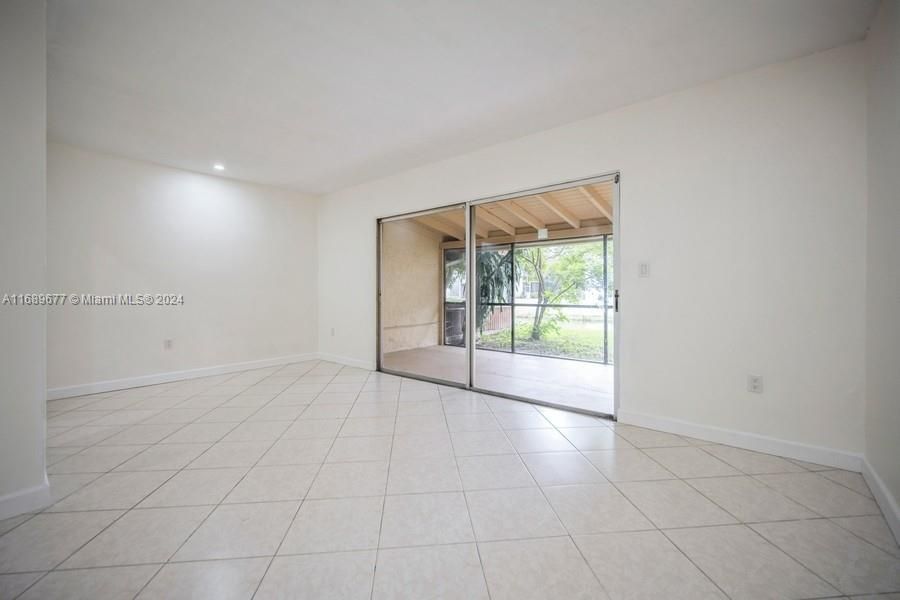 What a nice view from the Diningroom/Familyroom area overlooking the screened patio & grass that leads you to the waterway. That means you have no neighbors directly behind you!