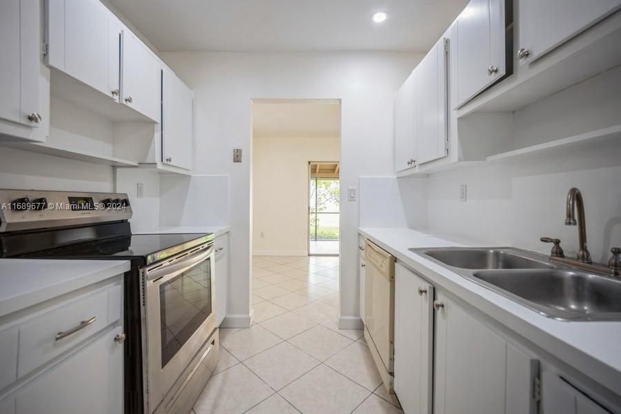 The kitchen in this picture looks better than it really is! We are priced below $450,000 so that you, in time, can re-do the kitchen after recovering from closing. The diningroom is beyond the kitchen opening.