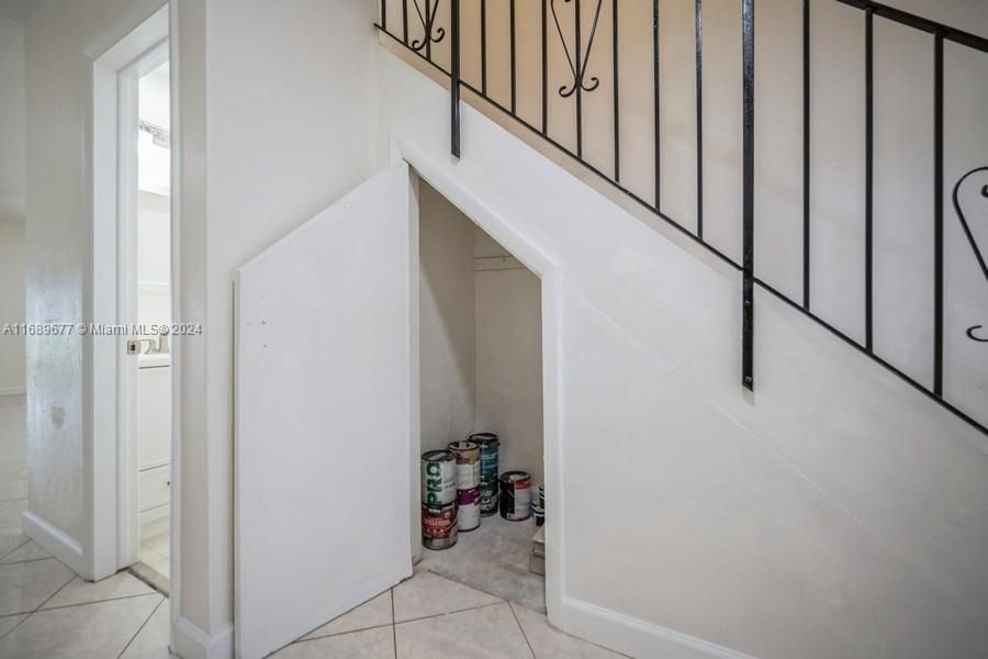 Here is the staircase closet where one can store luggage and bulky things that needs to be in air conditioning space! The "Powder-room" door is to the left of storage door.