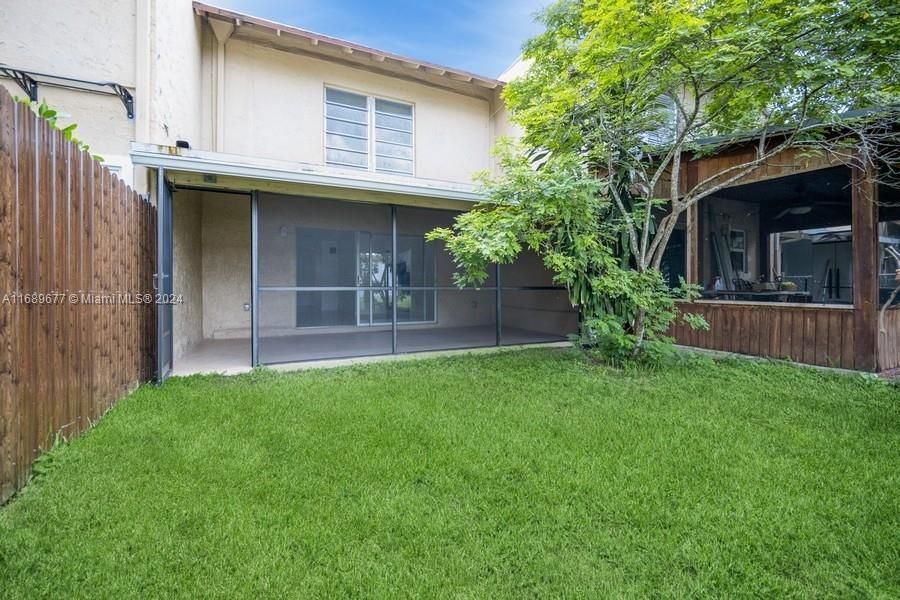 screened in patio leading to the backyard and waterway.