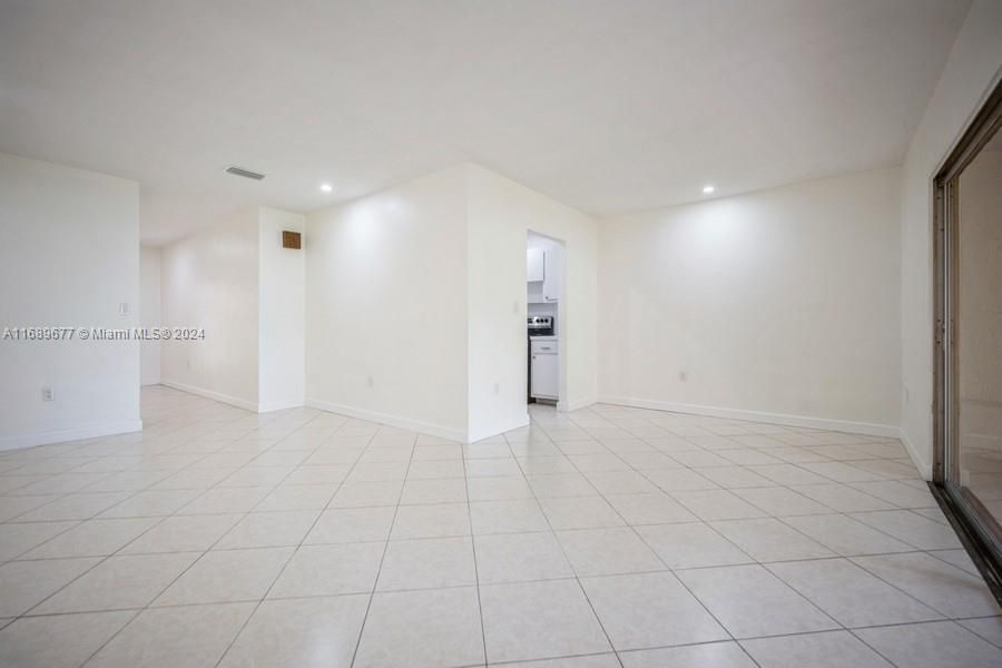 This picture shows you the livingroom space to the left and the Familyroom/Diningroom space to the right. Notice that the Diningroom has it's own recessed light on the ceiling and illuminating anything on the back wall.