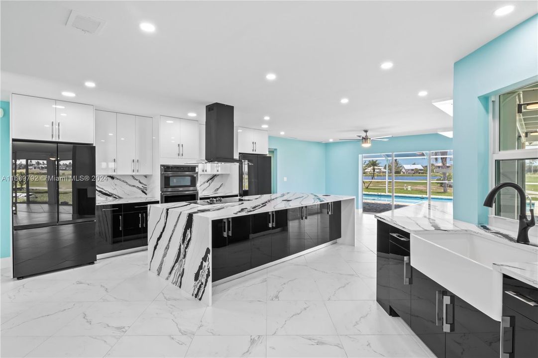 Unbelievable kitchen that is a statement not only in aesthetics but also in functionality! TONS of room on oversized kitchen island, multiple prep spaces and TWO refrigerators!