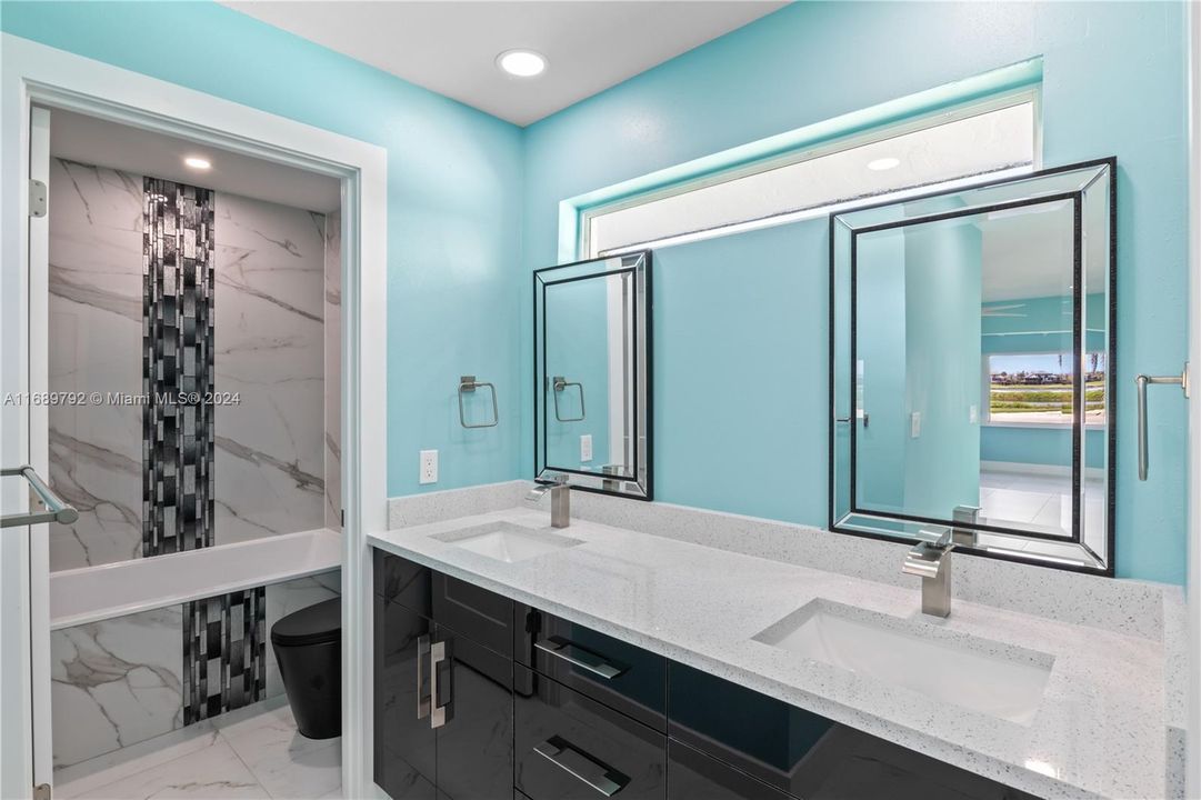 The primary bathroom is a luxurious spa like retreat with double vanity sinks, separate and private bath tub and a full walk in oversized shower that is wheel chair accessible.