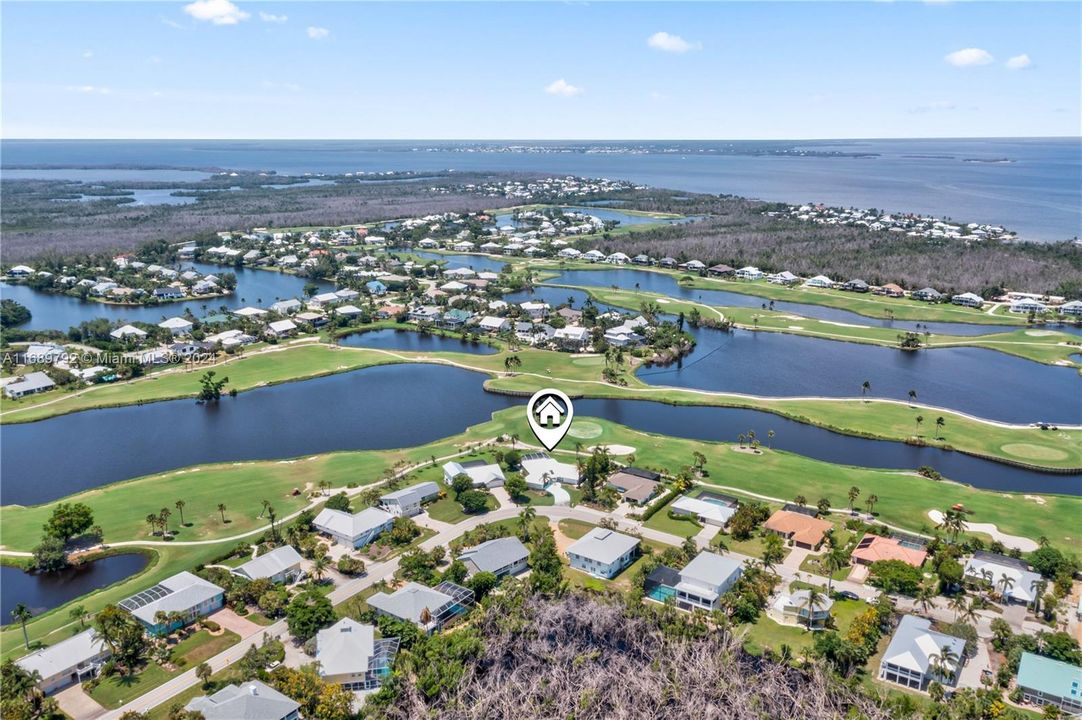 LOCATION LOCATION LOCATION! Beautiful aerial view of the home and the surrounding golf course and in the distance the blue waters of the Gulf of Mexico!