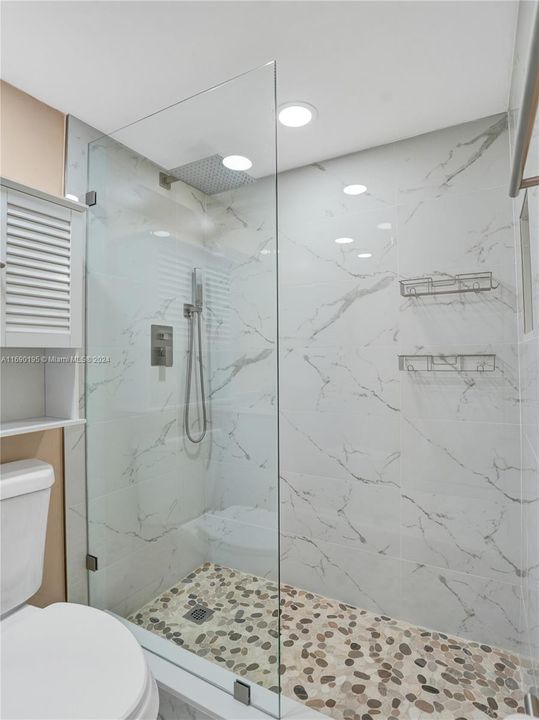 Updated Shower in the Owners Bath with a Cobblestone floor to massage your feet!