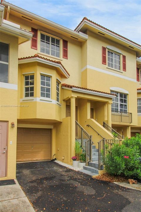 Exterior view of parking space in front and the 1 car enclosed garage.