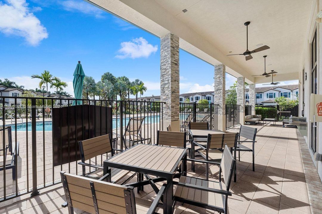 Community sitting area outside of clubhouse next to pool