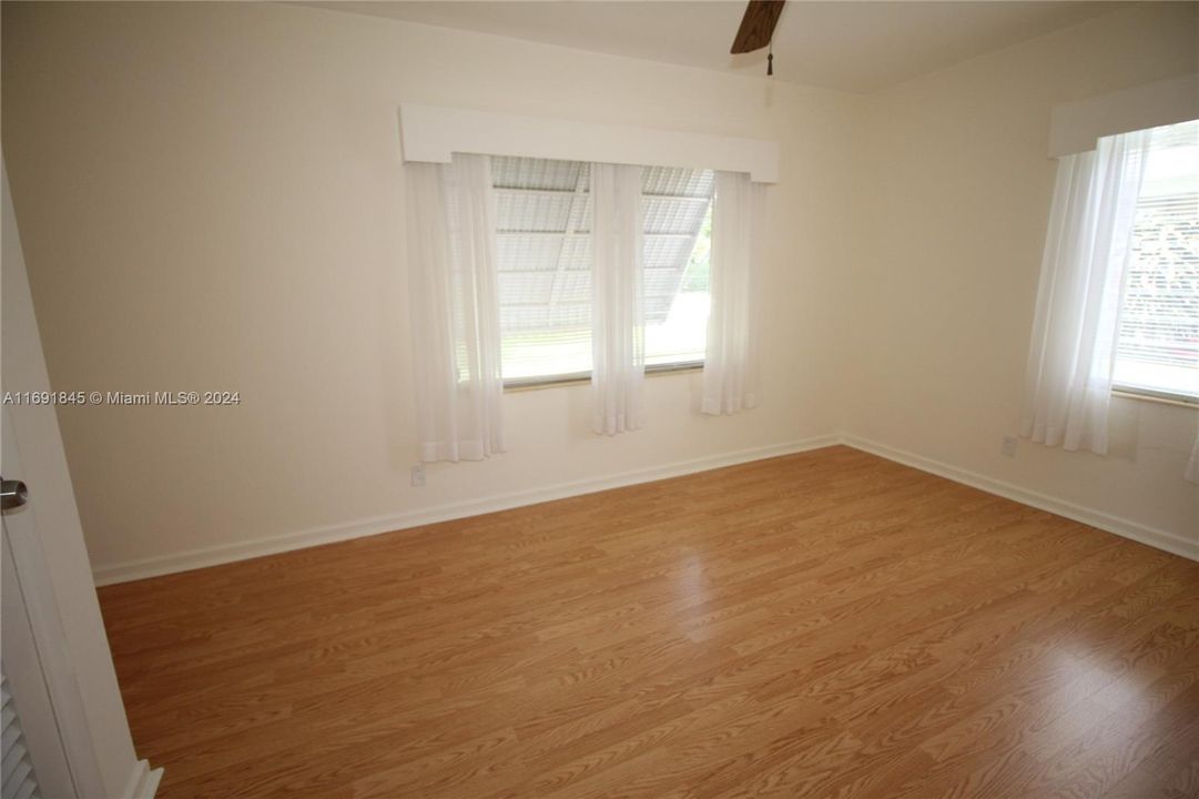 Bedroom has wood flooring.