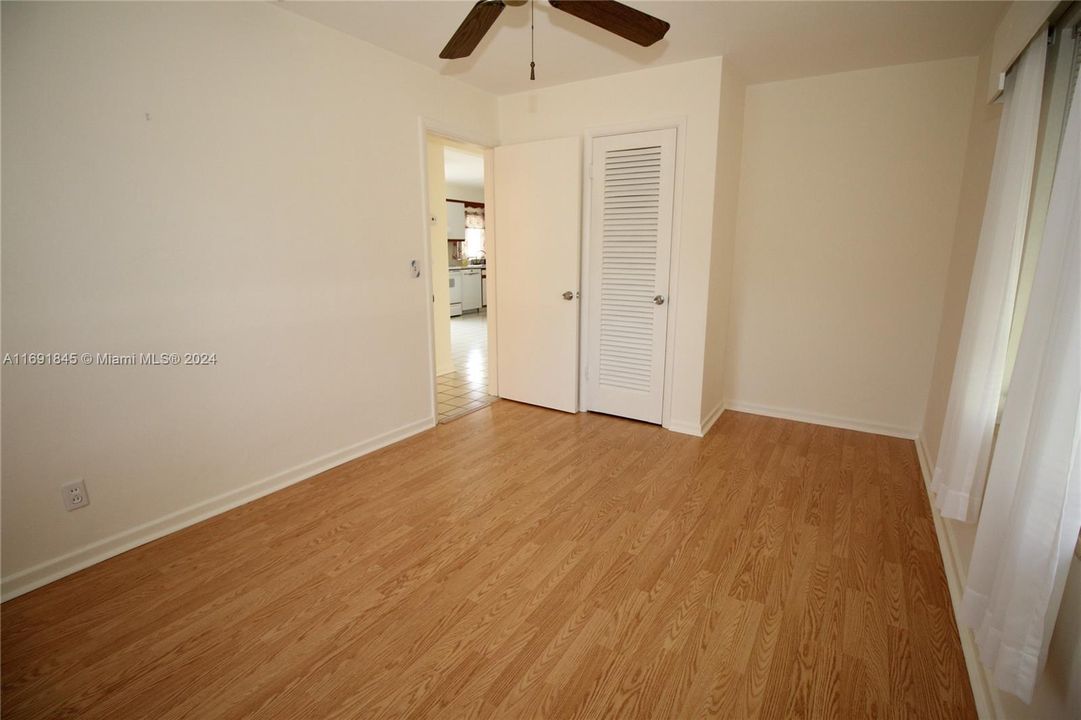 Bedroom has wood flooring.