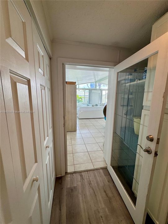 Hallway access to the Florida Room. W/D on left and storage pantry on right.