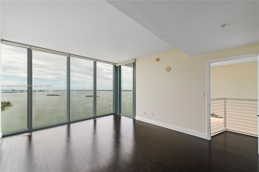 Master bedroom with floor to ceiling windows and beautiful wood through out