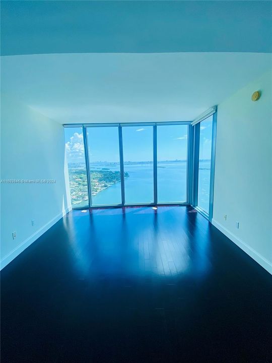 Master bedroom with floor to ceiling windows and beautiful wood through out