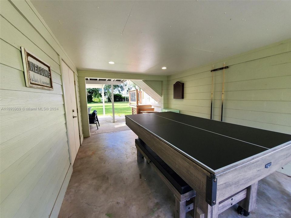 Ping-pong/ Pool Table. Laundry on left, facing river