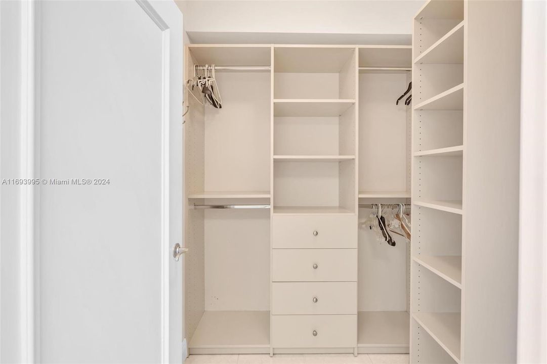 PRIMARY WALK IN CLOSET WITH CUSTOM CABINETRY