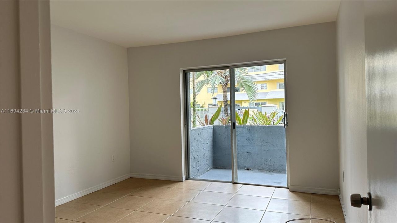 Bedroom with balcony access and garden view