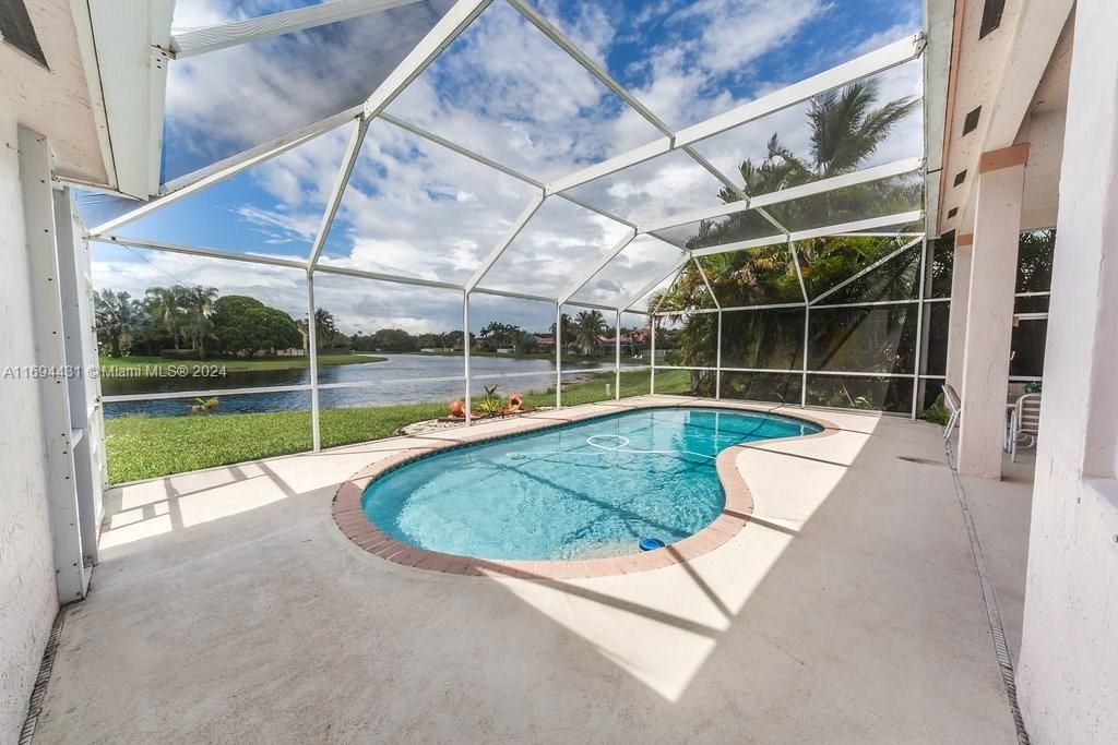 Lake view over pool screened in for easy pool maintenance and no mosquitos