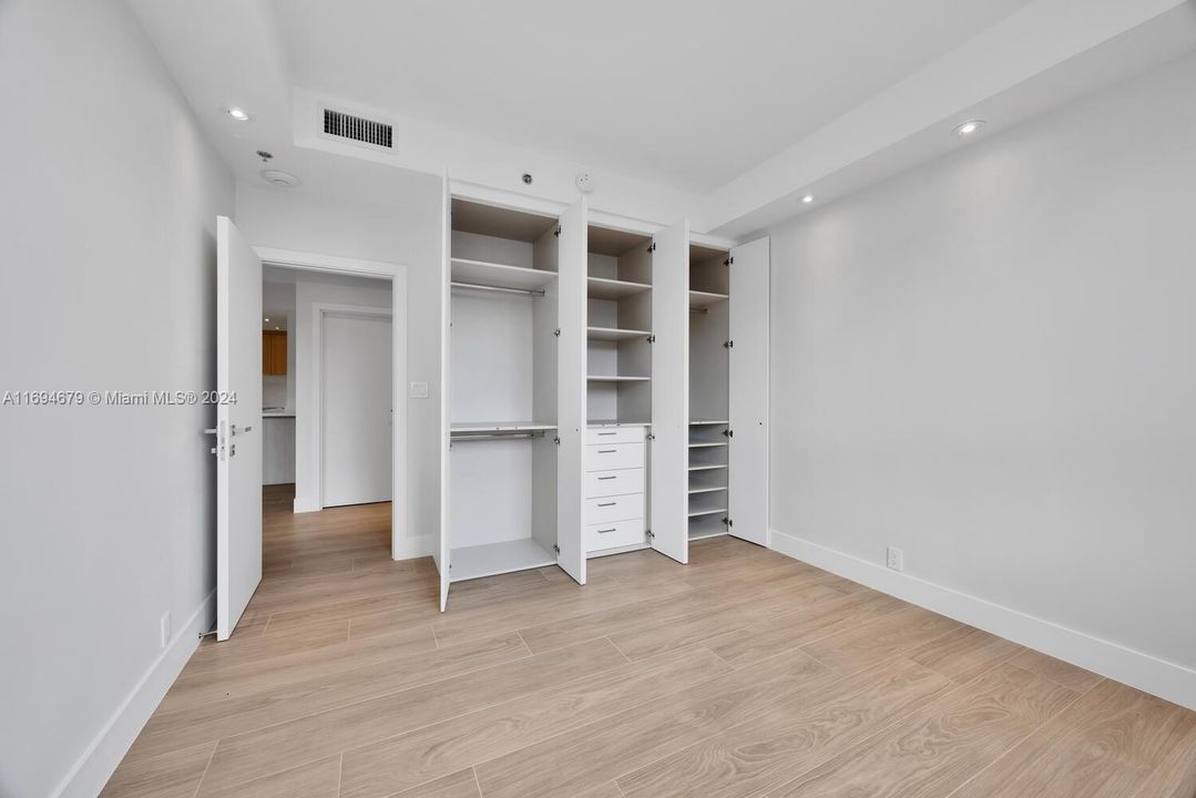 Guest built-out closet with extra drawer space.