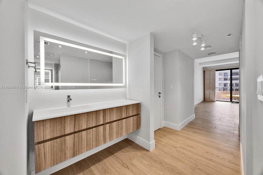 Master bath area has two separate lav areas with wall hung cabinetry and ample storage. Grohe fixtures.