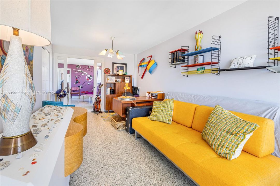 2ND BEDROOM WITH SLIDING GLASS DOORS LEADING INTO THE LARGE LIVING AREA