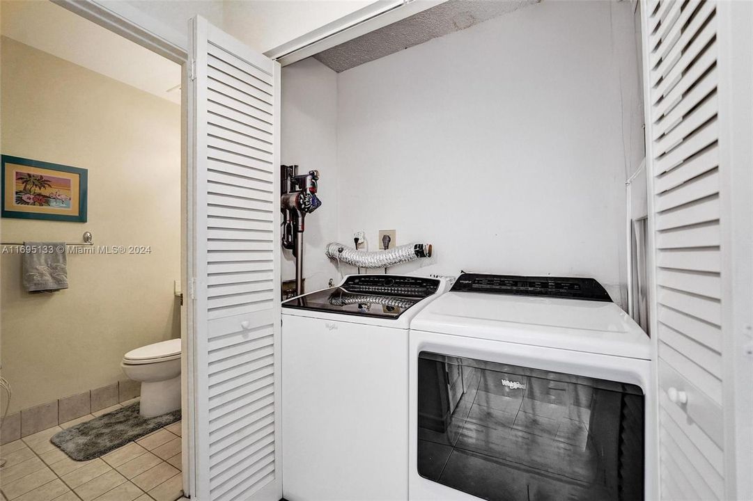 Washer Dryer with shelves above [not shown]