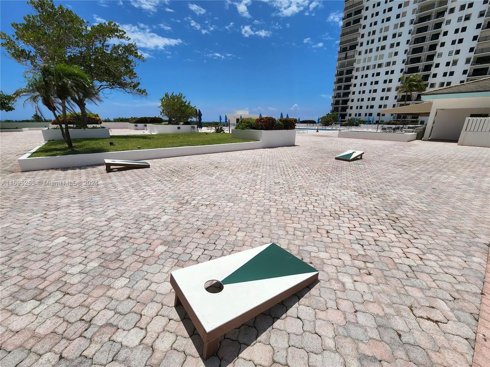 CORNHOLE on the pool deck .. 2 pools restaurant greenery and views to enjoy every day on the balcony or at the pool deck