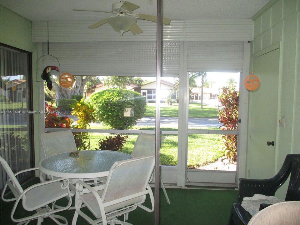 SCREENED PATIO AREA WITH SLIDING DOORS FROM MASTER BEDROOM & LIVING AREA